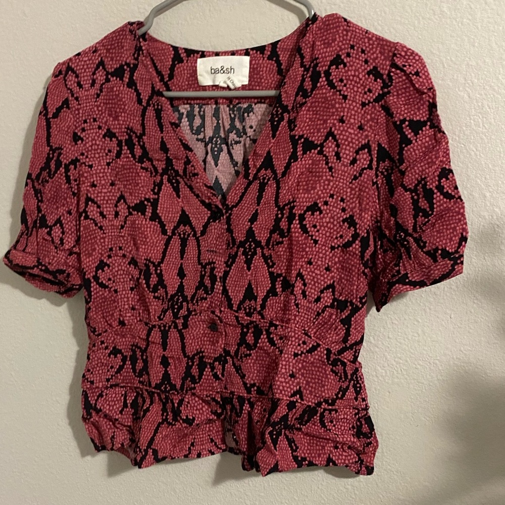 It’s a ba&sh small pink and black blouse